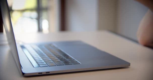 Close up view of young woman hold credit card use notebook computer typing number payments at home or office. — Stock Video