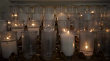 Close up scene of burning candles in the church. Slow camera truck move. High quality 4k footage