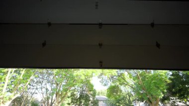 Automated garage Door opens and closes. View from inside of the residential house garage. Wide view. High quality 4k footage