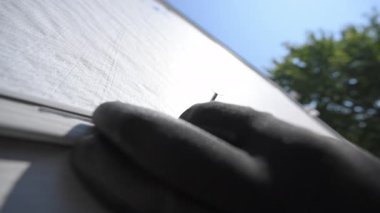 Bir işçi, konutun dış duvarına çivi çakıyor. Yüksek kalite 4k görüntü