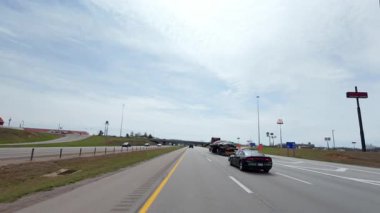 Otoyolda devriye ya da eskort araç eşliğinde giden büyük bir yük kamyonu. Parlak gündüz vakti büyük kargo taşımacılığı. ABD Elizabethtown KY 25 Mart 2025. Yüksek kalite 4k görüntü