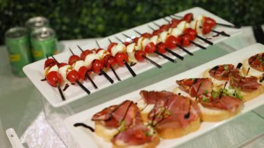 Cam tezgahlarda düzgünce sergilenen çeşitli gurme aperatifleri olan zarif bir açık büfe masası. Renkli abur cuburlar yemek ya da kutlama için iyi düzenlenir. Yüksek kalite 4k görüntü