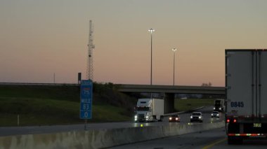 Kargo karavanı olan beyaz kamyonet gün batımında otoyolda trafikte yük taşıyor. Ulaşım, lojistik, teslimat. ABD Knoxville, TN 2 Kasım 2025. Yüksek kalite 4k görüntü