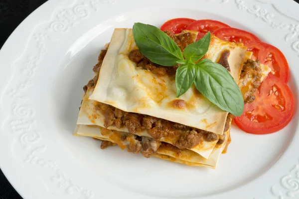Meat lasagna with basil. on a white plat — Stock Image Meat Lasagna Basil White Plat Stock Photo