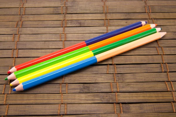 Colored pencils on a wooden board — Stock Photo, Image