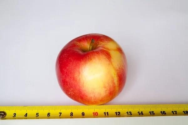 Apple with a ruler — Stock Photo, Image