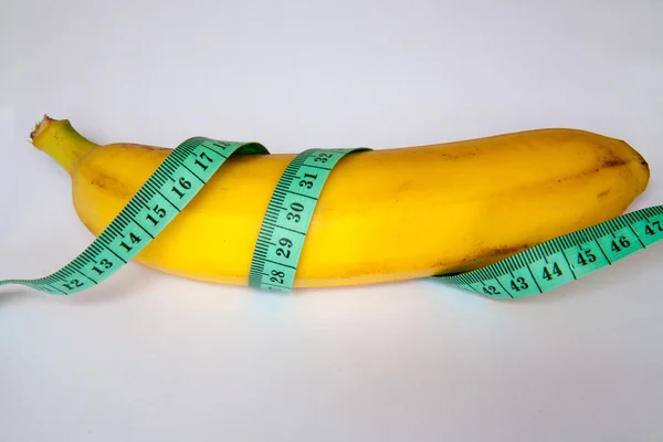 Banana with a ruler — Stock Photo, Image