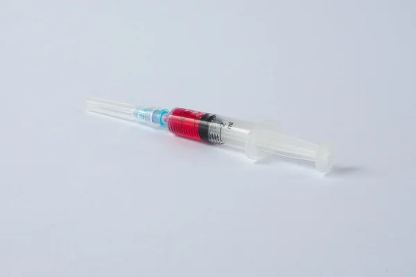 Syringe with red liquid — Stock Photo, Image