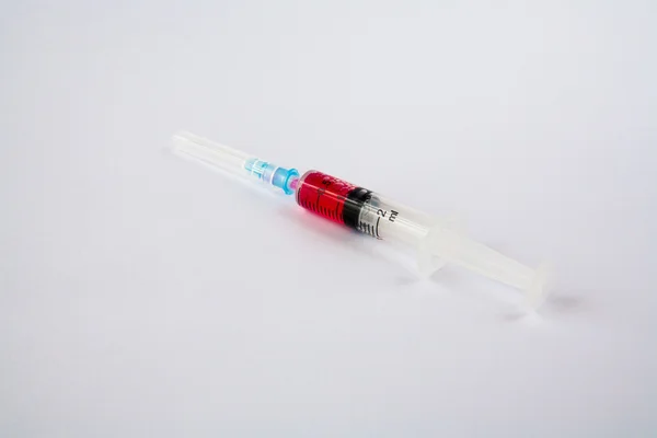 Syringe with red liquid — Stock Photo, Image