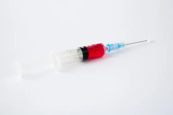 Syringe with red liquid — Stock Photo, Image