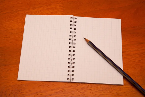 Pencil on a notebook — Stock Photo, Image