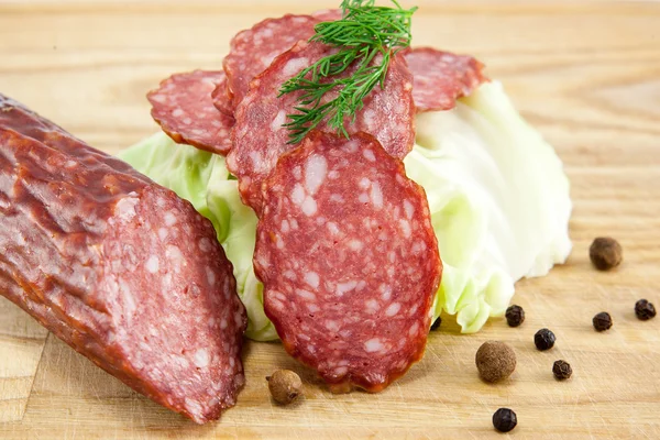 Salami sausages on wooden board isolated — Stock Photo, Image