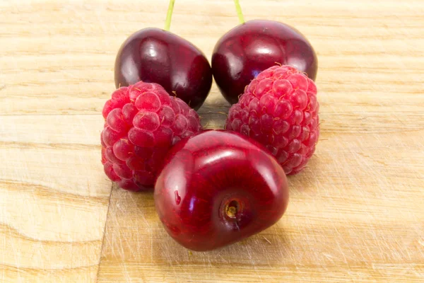 Raspberries with cherries — Stock Photo, Image