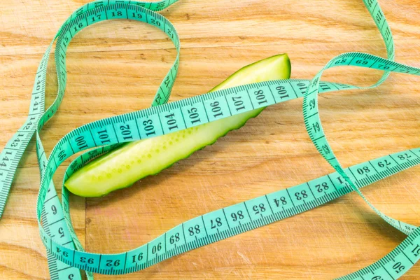 Cucumber with tape measure — Stock Photo, Image