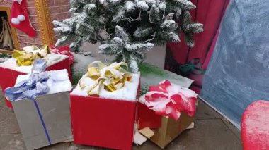 Christmas presents in colorful wrapping paper on the floor under Christmas tree. Surprises, memories, happy winter time concept