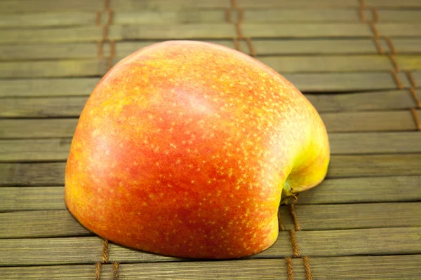 Яблоко на деревянном полу — стоковое фото
