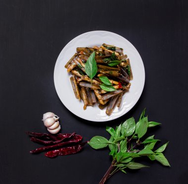 Razor clams spicy Stir-Fry on black background, top view clipart
