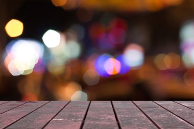 Empty old wooden deck table with foliage bokeh for background