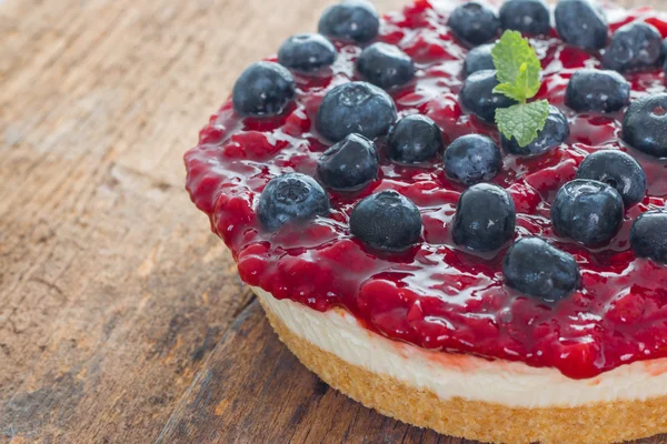 Strawberry cheese pie with fresh blueberry on wood — Stock Photo, Image