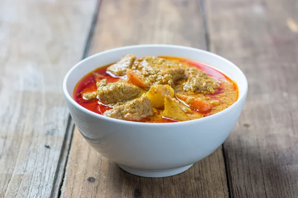 Pork Mussaman curry on wood background — Stock Image Pork Mussaman curry on wood background Stock Photo