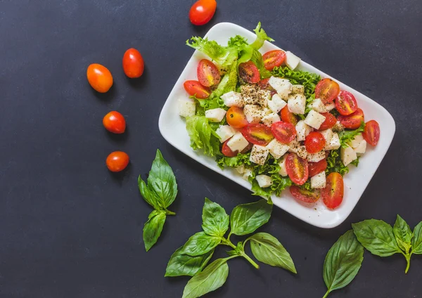 Italian salad, Tomato mozzarella basil leave salad. Top view on — Stock Photo, Image