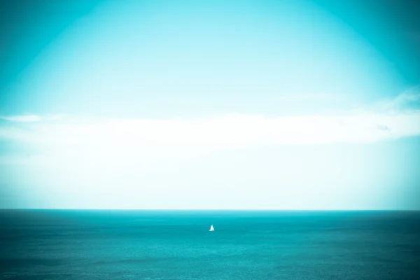 Blue sky and blue sea with loney ship, vintage tone — Stock Photo, Image