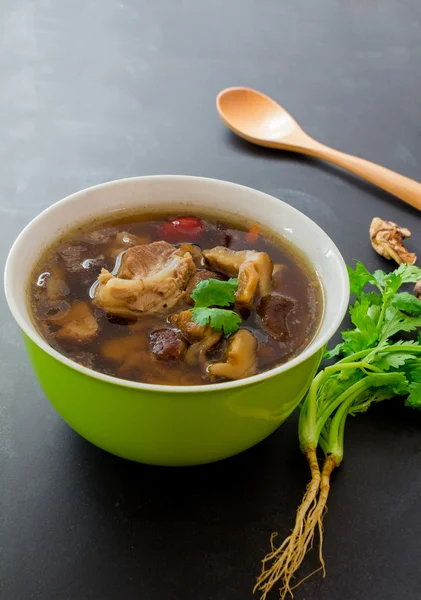 Top view, stew of pork and herbal soup, ba kut teh on black back — Stock Image Top view, stew of pork and herbal soup, ba kut teh on black back Royalty Free Stock Photos