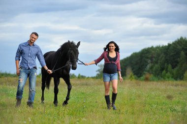 Çocuğunu bekliyor. Çayırda yürüyorum. Genç bir çift - o uzun saçlı esmer bir kadın, hamile; uzun boylu ve cesur, siyah atın dizginlerini tutan, çayırda bir yürüyüş.