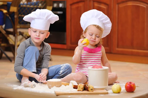 Two Siblings Boy Girl Chef Hats Fireplace Sitting Kitchen Floor — Stock Photo, Image