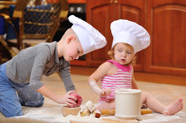 Two Siblings Boy Girl Chef Hats Fireplace Sitting Kitchen Floor — Stock Photo, Image