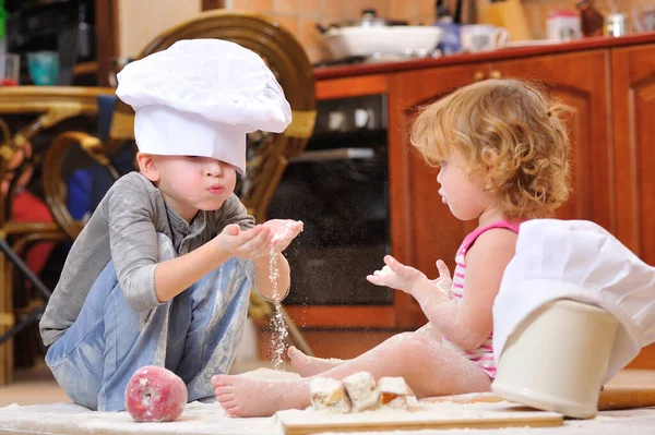 Two Siblings Boy Girl Chef Hats Fireplace Sitting Kitchen Floor — Stock Photo, Image