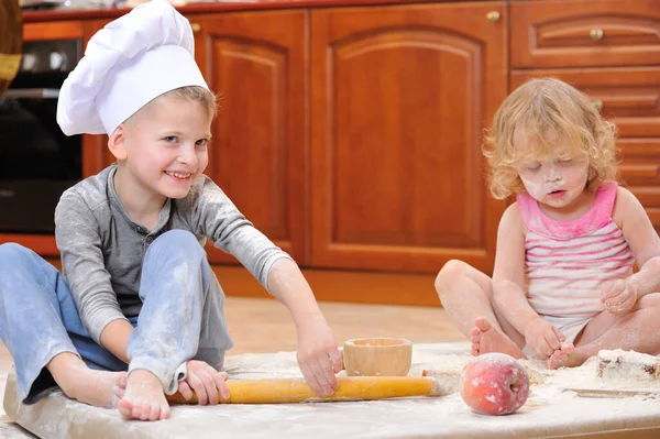 Two Siblings Boy Girl Chef Hats Fireplace Sitting Kitchen Floor — Stock Photo, Image