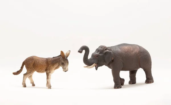 Toy donkey and elephant. In the United States, political parties are represented by either a Democratic donkey or a Republican elephant.  isolated on a white background