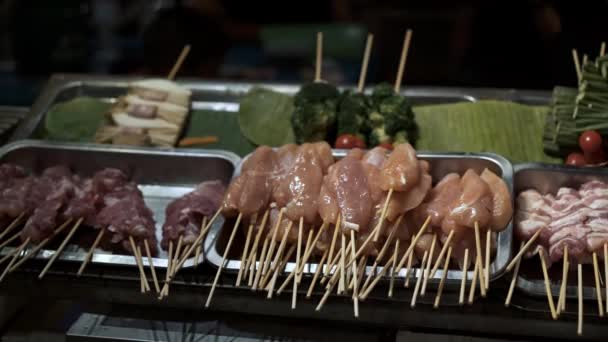 Pan shot of thai raw street meat and food on sticks — Stock Video