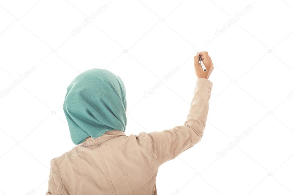 Back view of muslimah business woman writing something on white 