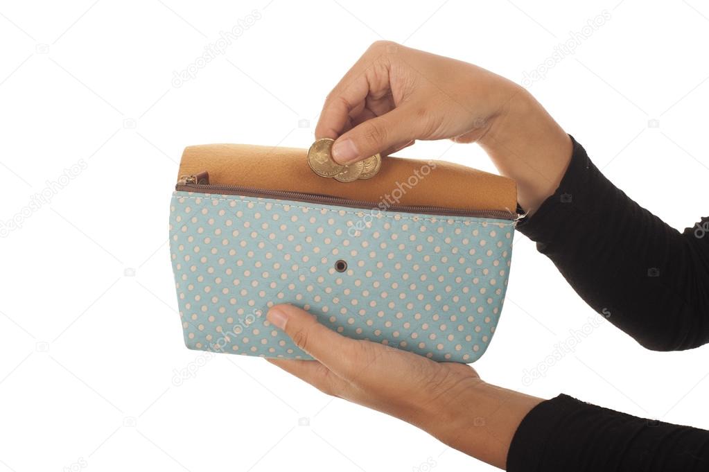 Woman hand put money in purse isolated on white background