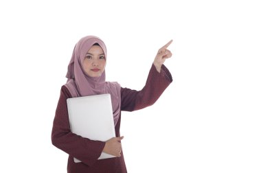 Genç çekici muslimah işkadını bir laptop tutar.