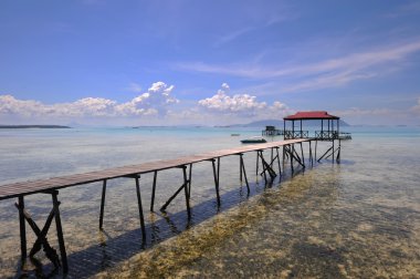 Wooden jetty headding towards the sea at Sabah National Park in  clipart