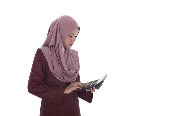 Atraente jovem muslimah empresária segurando uma calculadora . — Fotografia de Stock