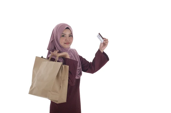 Uma mulher muçulmana feliz segurando um monte de sacos de papel de compras e — Fotografia de Stock