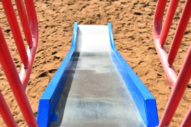 Bir çocuk parkında parlak renkli bir slaytın görüntüsü. 