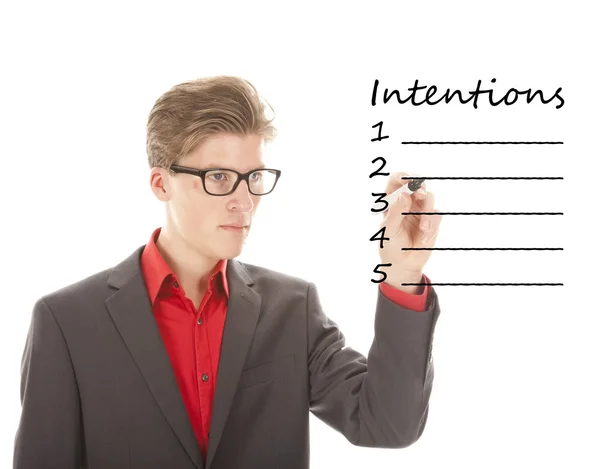 Jovem escrevendo intenções isoladas em fundo branco — Fotografia de Stock