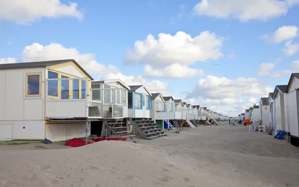 Beach houses on beach in a row with blue sky Royalty Free Stock Photos