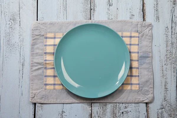 Empty plate on light blue wooden background — Stock Photo, Image