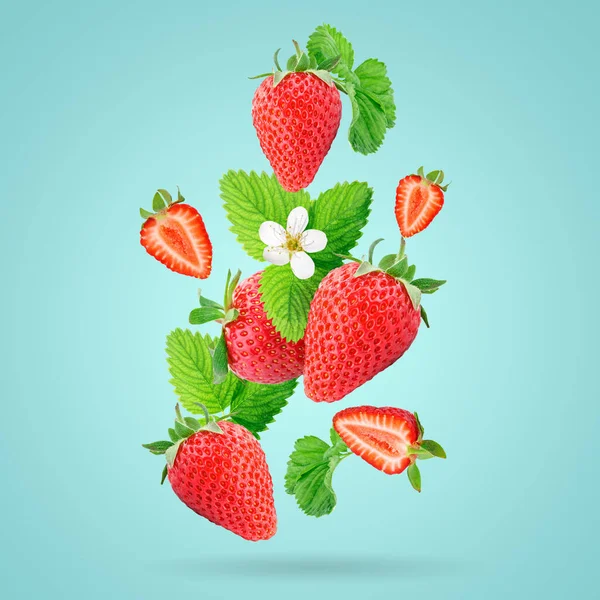 Strawberry berries levitating on a blue background. Horizontal. Selective focus. — Stock Photo, Image