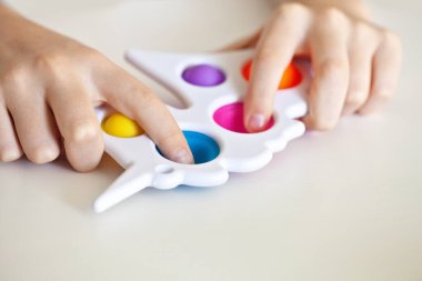 Silikon oyuncak bir gencin ellerinde anti-stres. Stres önleyici renkli oyuncak. Yeni moda. Renkli stres önleyici oyuncaklar. Kıpırdayın. Kıpırdayın..