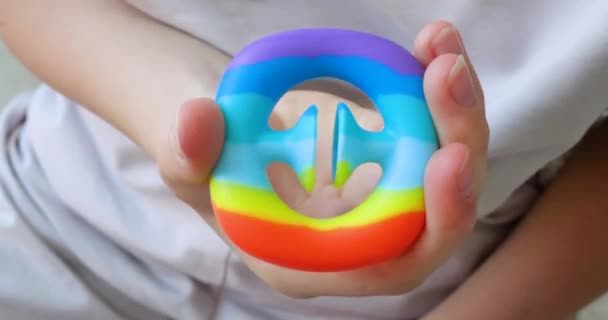 Kind spielt trendy beliebtes Brettspiel Anti-Stress-Spielzeug Pop it. Vielfarbiges beliebtes Silikon-Anti-Stress-Spielzeug. — Stockvideo