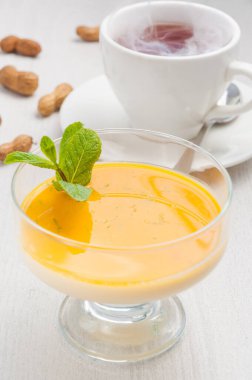 Lezzetli Pana cotta tatlı, mango ve sıcak çay.