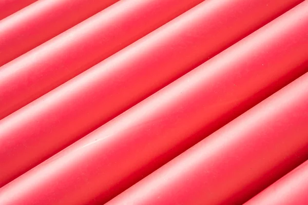 Stack of red pvc protective pipes — Stock Photo, Image