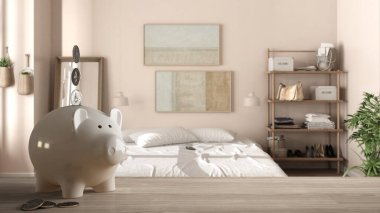 Ahşap masa ya da raflı, içinde bozuk paralar olan beyaz domuz kumbarası yumuşak yataklı ahşap yatak odası, pahalı iç tasarım, yenileme konsepti mimarisi.